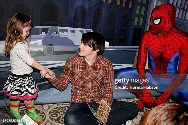 Actor Drake Bell reads to a group of children at the "Reading With: Marvel Comics Close-Up" kick-off event at the Burbank Public Library on January...