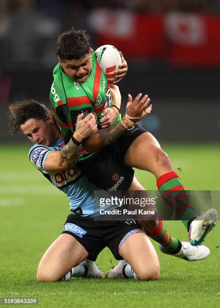 Nicholas Hynes of the Sharks tackles Latrell Mitchell of the Rabbitohs during the round 23 NRL match between South Sydney Rabbitohs and Cronulla...