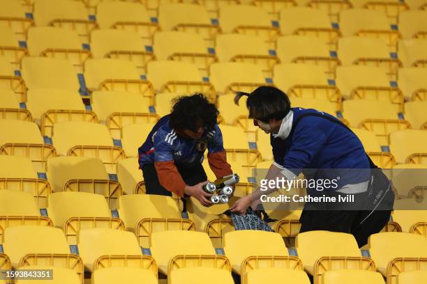 Fans of Japan clean the stadium after the FIFA Women's World Cup Australia & New Zealand 2023 Round of 16 match between Japan and Norway at...