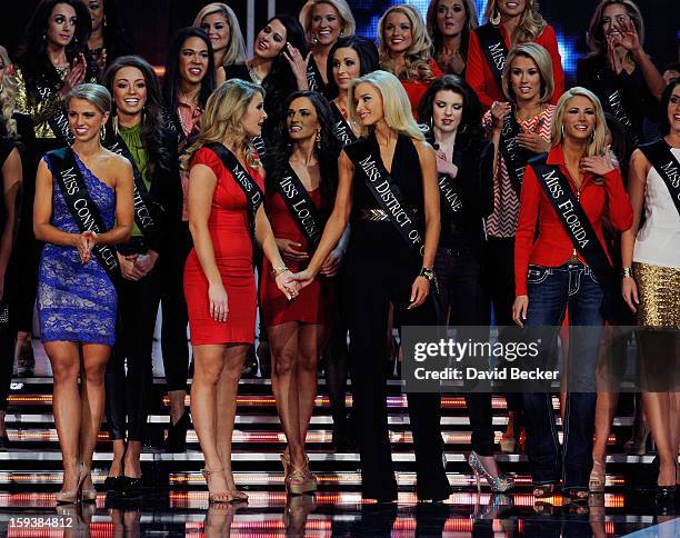Alyssa Murray , Miss Delaware, and Allyn Rose, Miss District of Columbia hold hands during the 2013 Miss America Pageant at PH Live at Planet...