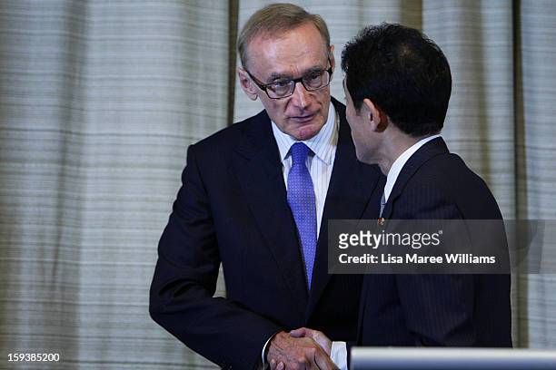 Australian Foreign Minister Bob Carr shakes hands with Japanese Foreign Minister Fumio Kushida during a press conference during bilateral meetings at...