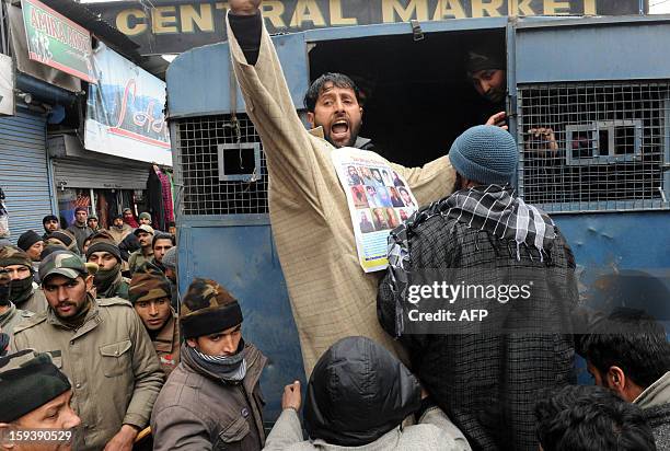 Supporter of the pro-independence Jammu and Kashmir Libration Front shouts anti-India slogans from a police van during a "jail bharo" agitation to...