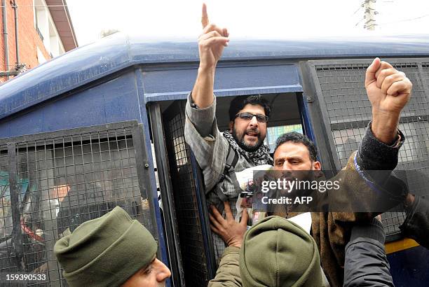 Supporters of the pro-independence Jammu and Kashmir Libration Front shouts anti-India slogans from a police van during a "jail bharo" agitation to...