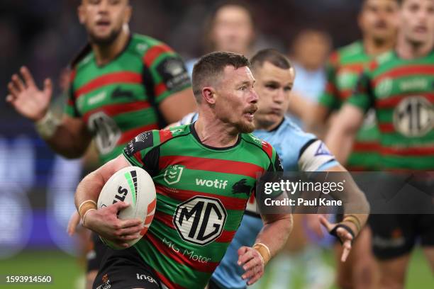 Damien Cook of the Rabbitohs runs the ball during the round 23 NRL match between South Sydney Rabbitohs and Cronulla Sharks at Optus Stadium on...