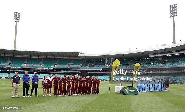 The NSW and Queensland teams line up for the national anthem before the start of play at the WNCL Final match between the NSW Breakers and the...