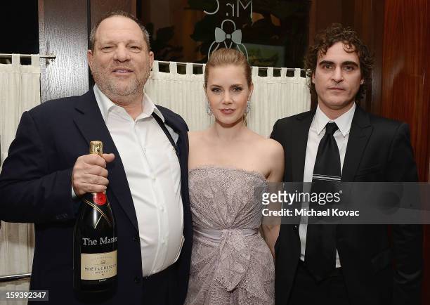 Producer Harvey Weinstein, actress Amy Adams, and actor Joaquin Phoenix attend Moet & Chandon and the HFPA Toast The Weinstein Company Golden Globe...