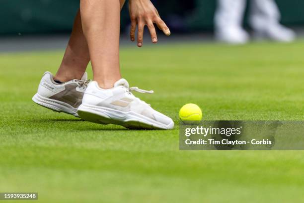 Ball girl retrieves the tennis ball off the grass on Court One during the Wimbledon Lawn Tennis Championships at the All England Lawn Tennis and...