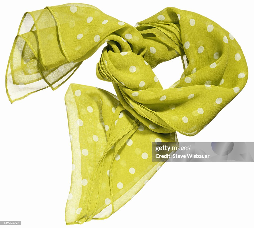 A sheer lime green scarf with white polka dots