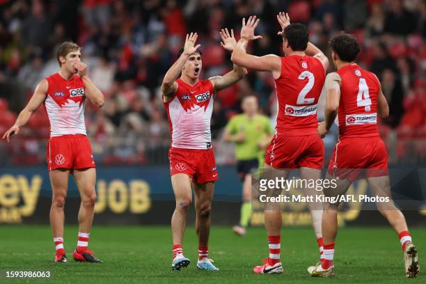 Sam Wicks of the Swans celebrates with team mates after kicking a goal during the round 21 AFL match between Greater Western Sydney Giants and Sydney...