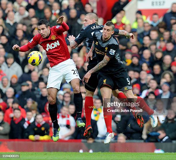 Daniel Agger and Martin Skrtel of Liverpool go up with Robin Van Persie of Manchester during the Barclays Premier League match between Manchester...