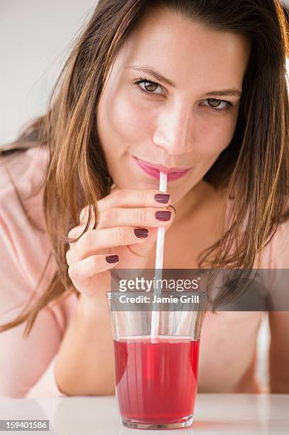 woman drinking cranberry juice - cranberry juice stock pictures, royalty-free photos & images
