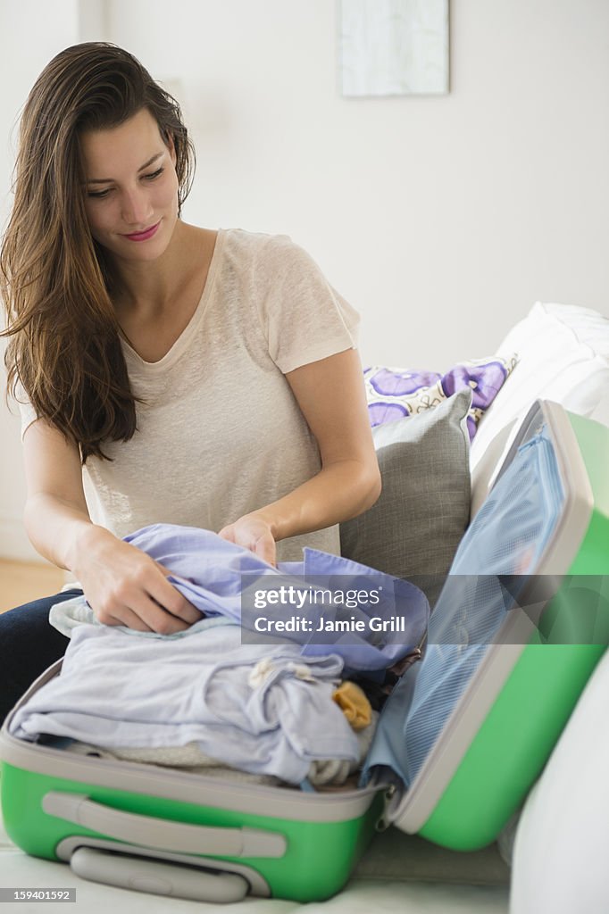 Woman packing suitcase