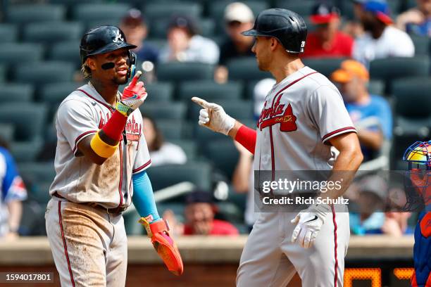 Matt Olson of the Atlanta Braves is congratulated by Ronald Acuna Jr. #13 after hitting a three-run home run against the New York Mets in the sixth...