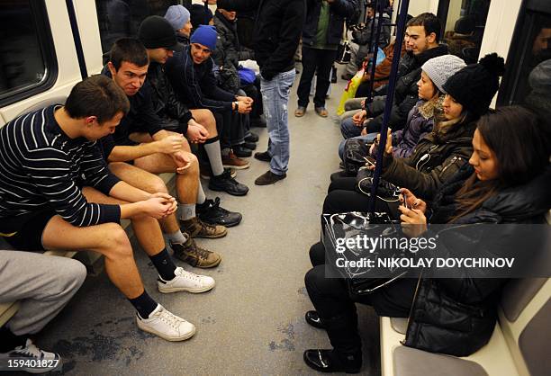 People sit in underwear in the Sofia City subway as they take part in the 2013 No Pants Subway Ride on January 13, 2013 in the Bulgarian capital. The...