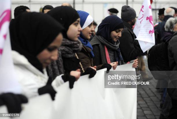 Veiled women take part in a protest against same-sex marriage on January 13, 2013 in Paris. Tens of thousands march in Paris on January 13 to...