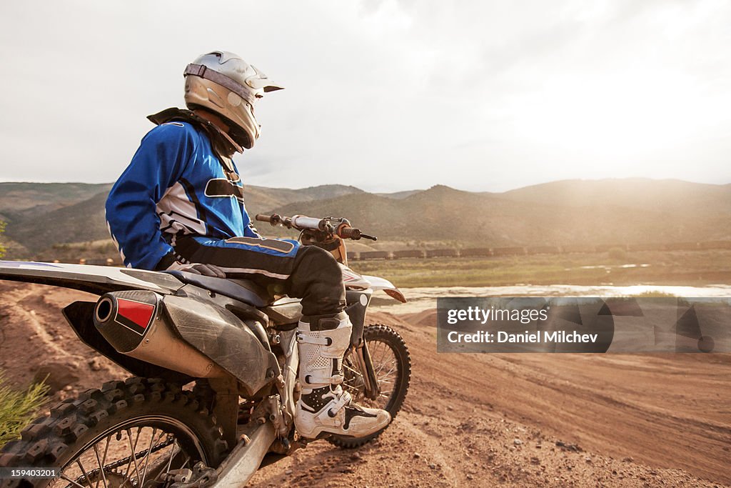 Biker looking at the sunset.