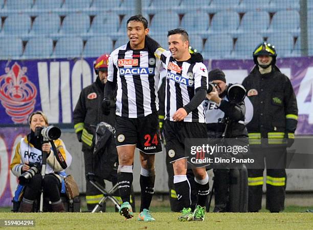 Fernando Muriel of Udinese Calcio celebrates after scoring his team's third goal with team mate Antonio Di Natale during the Serie A match between...
