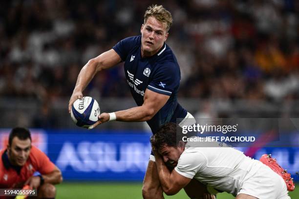 Scotland's wing Duhan van der Merwe is tackled by France's scrum-half Antoine Dupont during the pre-World Cup Rugby Union friendly match between...