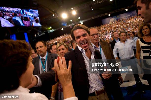 Spain's former Prime Minister Jose Maria Aznar greets supporters during the Popular Party National Congress, on October 8, 2011 in Malaga, southern...