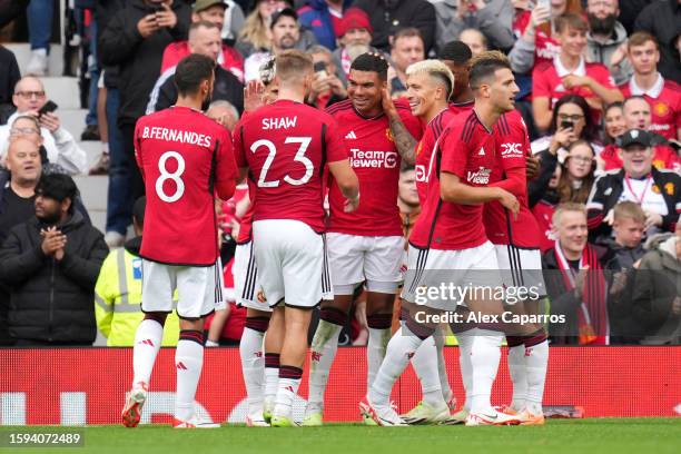 Casemiro of Manchester United celebrates with teammates after scoring the team's third goal during the pre-season friendly match between Manchester...