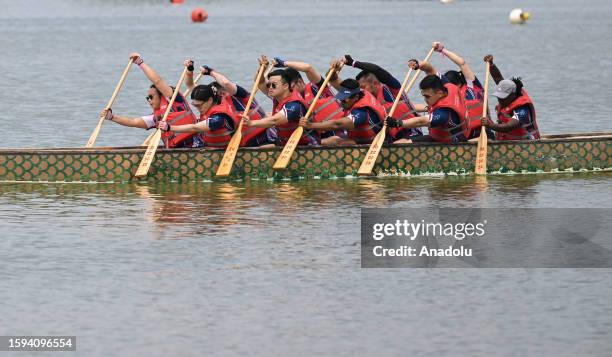 People are seen on the dragon-headed boat during the Hong Kong Dragon Boat Festival held at the Flushing Meadows-Corona Park in New York, United...