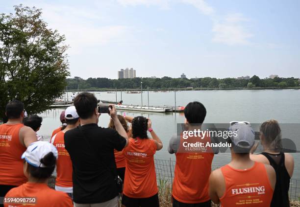 People take photos during the Hong Kong Dragon Boat Festival held at the Flushing Meadows-Corona Park in New York, United States on August 12, 2023....