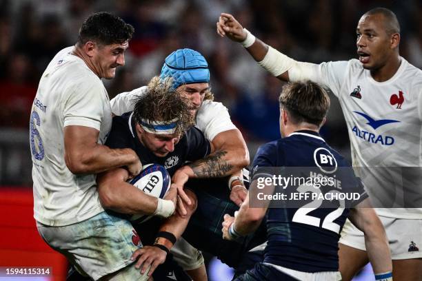 Scotland's flanker Jamie Ritchie is tackled by France's lock Bastien Chalureau and France's flanker Paul Boudehent during the pre-World Cup Rugby...