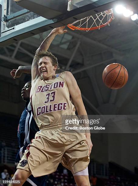 Boston College Eagles player Patrick Heckmann slam dunks over St. Francis Terriers player Kevin Douglas during second half action at Conte Forum on...