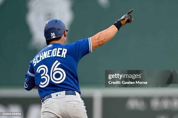 Davis Schneider of the Toronto Blue Jays rounds the bases after hitting a home run on his first at bat in his MLB debut during the second inning...