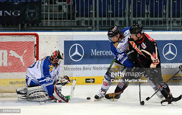 Ivan Ciernik of Hannover and Rene Kramer of Straubing battle for the puck during the DEL match between Hannover Scorpions and Straubing Tigers at TUI...