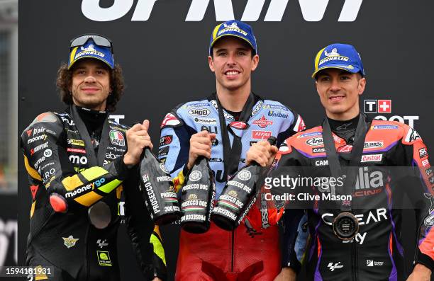 Second place finisher Marco Bezzecchi of Italy, first placed finisher Alex Marquez of Spain and thrid placed finisher Maverick Vinales of Spain...