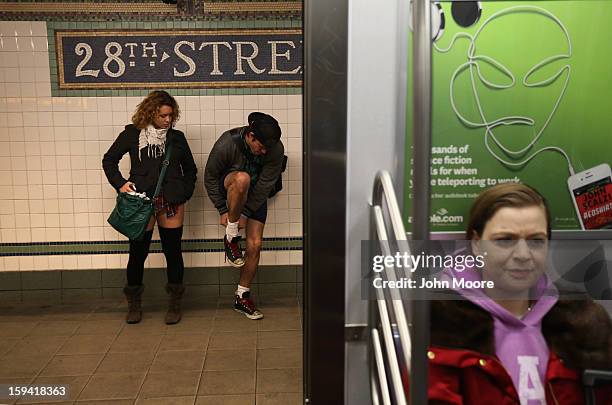 Pantless people stand on a subway platform on January 13, 2013 in New York City. Thousands of people participated in the 12th annual No Pants Subway...