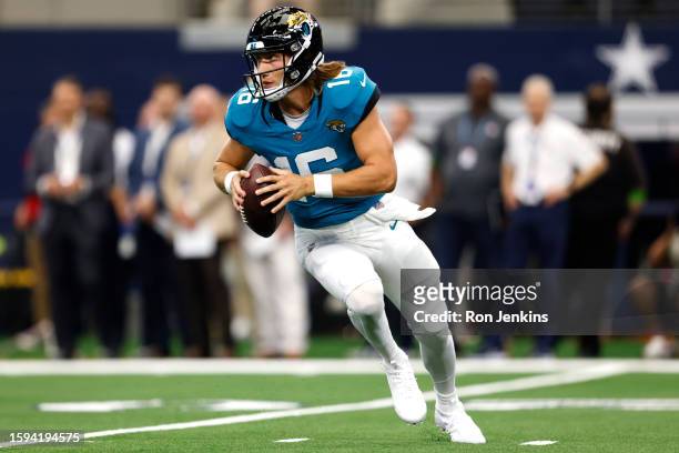 Trevor Lawrence of the Jacksonville Jaguars looks to pass against the Dallas Cowboys during the first half of a preseason game at AT&T Stadium on...