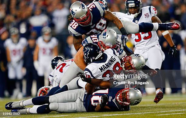 Danieal Manning of the Houston Texans gets tackled by Matthew Slater, Niko Koutouvides, Marquice Cole, and Brandon Bolden of the New England Patriots...