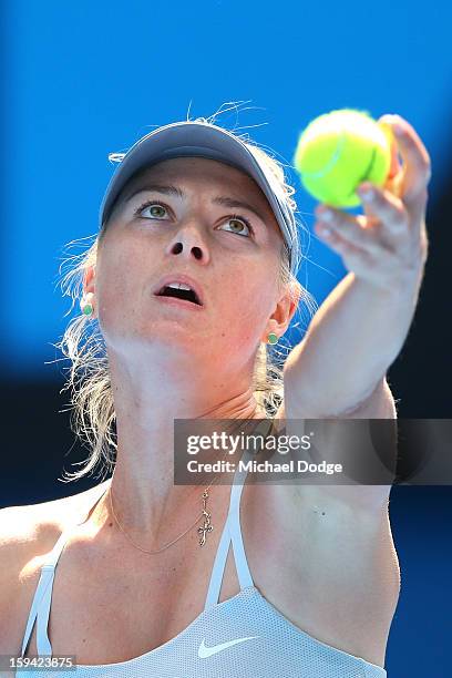 Maria Sharapova of Russia serves in her first round match against Olga Puchkova of Russia during day one of the 2013 Australian Open at Melbourne...