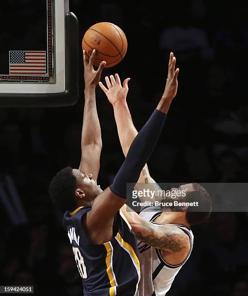 Deron Williams of the Brooklyn Nets scores two past Ian Mahinmi of the Indiana Pacers in the fourth quarter at the Barclays Center on January 13,...