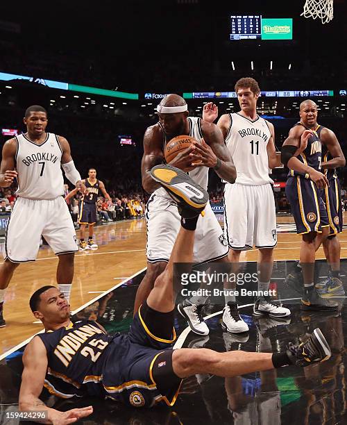 Reggie Evans of the Brooklyn Nets and Gerald Green of the Indiana Pacers battle over a loose ball in the fourth quarter at the Barclays Center on...