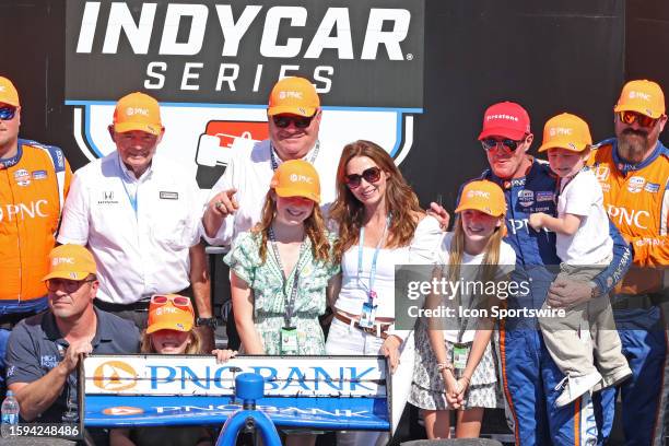IndyCar driver Scott Dixon poses for photo with his wife Emma Davies-Dixon and their 3 children and car owner Chip Ganassi after winning the...
