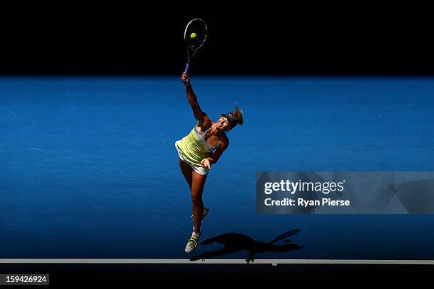 Maria Sharapova of Russia serves in her first round match against Olga Puchkova of Russia during day one of the 2013 Australian Open at Melbourne...