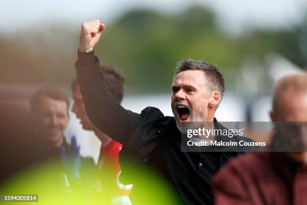 Dons Head Coach Graham Alexander celebrates following the Sky Bet League Two match between Wrexham and Milton Keynes Dons at Stok Cae Ras stadium on...