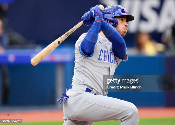 Cody Bellinger of the Chicago Cubs hits an RBI single against the Toronto Blue Jays during the fourth inning at the Rogers Centre on August 12, 2023...