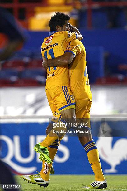 Damian Alvarez of Tigres celebrates with teammates a scored goal against Atlante during a match as part of the Clausura 2013 Liga MX at Andres...