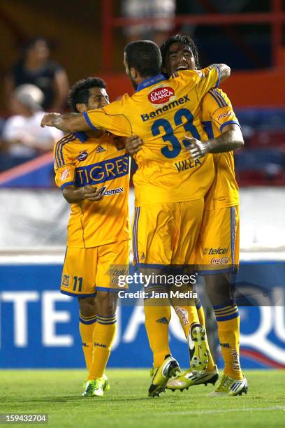 Damian Alvarez of Tigres celebrates with teammates a scored goal against Atlante during a match as part of the Clausura 2013 Liga MX at Andres...