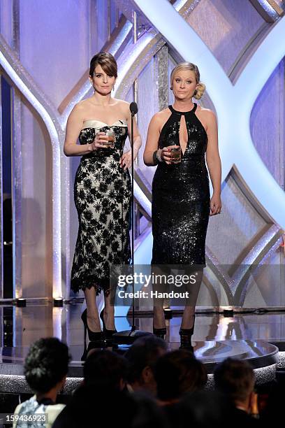 In this handout photo provided by NBCUniversal, L to R Tina Fey and Amy Poehler host the 70th Annual Golden Globe Awards at the Beverly Hilton Hotel...