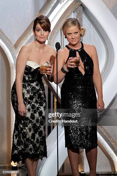 In this handout photo provided by NBCUniversal, L to R Tina Fey and Amy Poehler host the 70th Annual Golden Globe Awards at the Beverly Hilton Hotel...