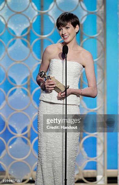 In this handout photo provided by NBCUniversal, Actress Anne Hathaway accepts the Best Supporting Actress award for Motion Picture, "Les Miserables"...