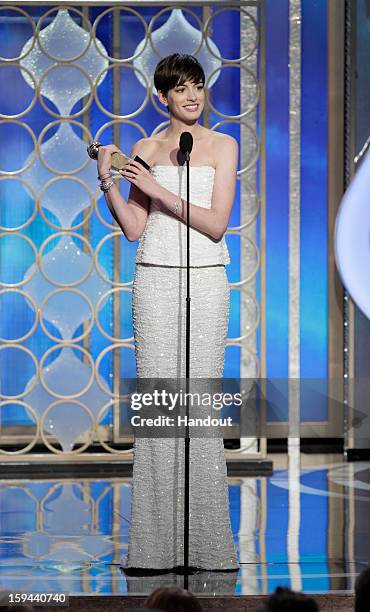 In this handout photo provided by NBCUniversal, Actress Anne Hathaway accepts the Best Supporting Actress award for Motion Picture, "Les Miserables"...