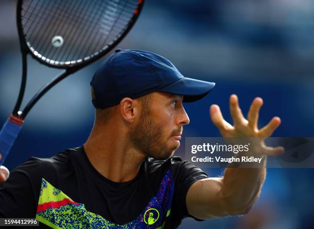 Tim Puetz of Germany hits a shot against Rajeev Ram of the United States and Joe Salisbury of Great Britain during Day Six of the National Bank Open,...