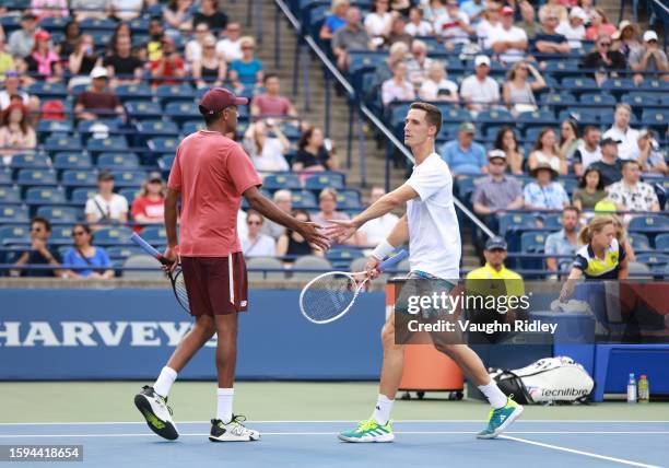Rajeev Ram of the United States and Joe Salisbury of Great Britain celebrate a point against Kevin Krawietz of Germany and Tim Puetz of Germany...