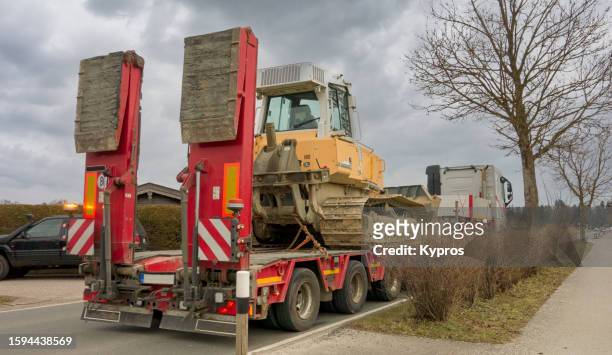 vehicle transporter truck carrying bulldozer - transporter stock pictures, royalty-free photos & images